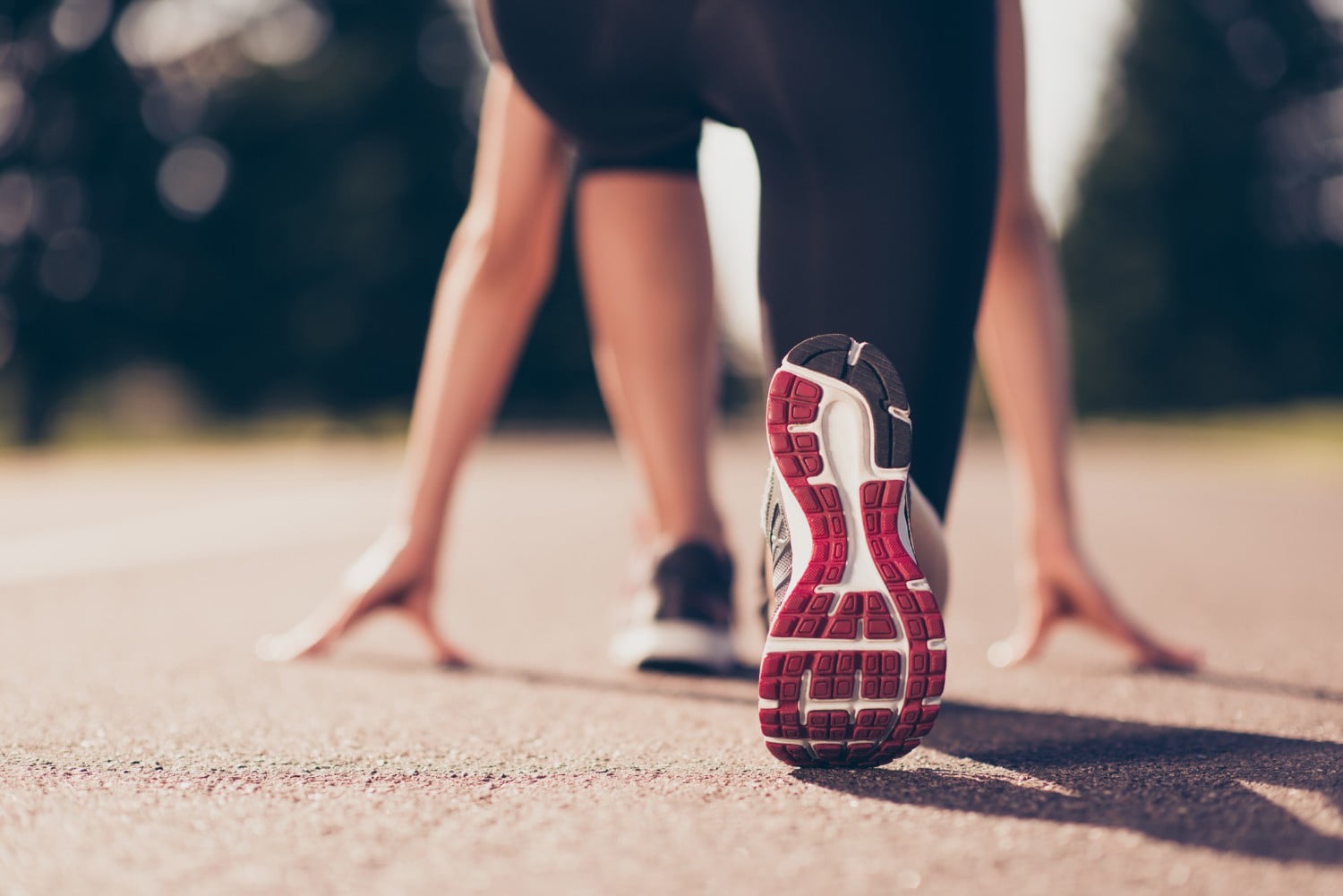 Underneath of woman's sneaker as she braces for a race.