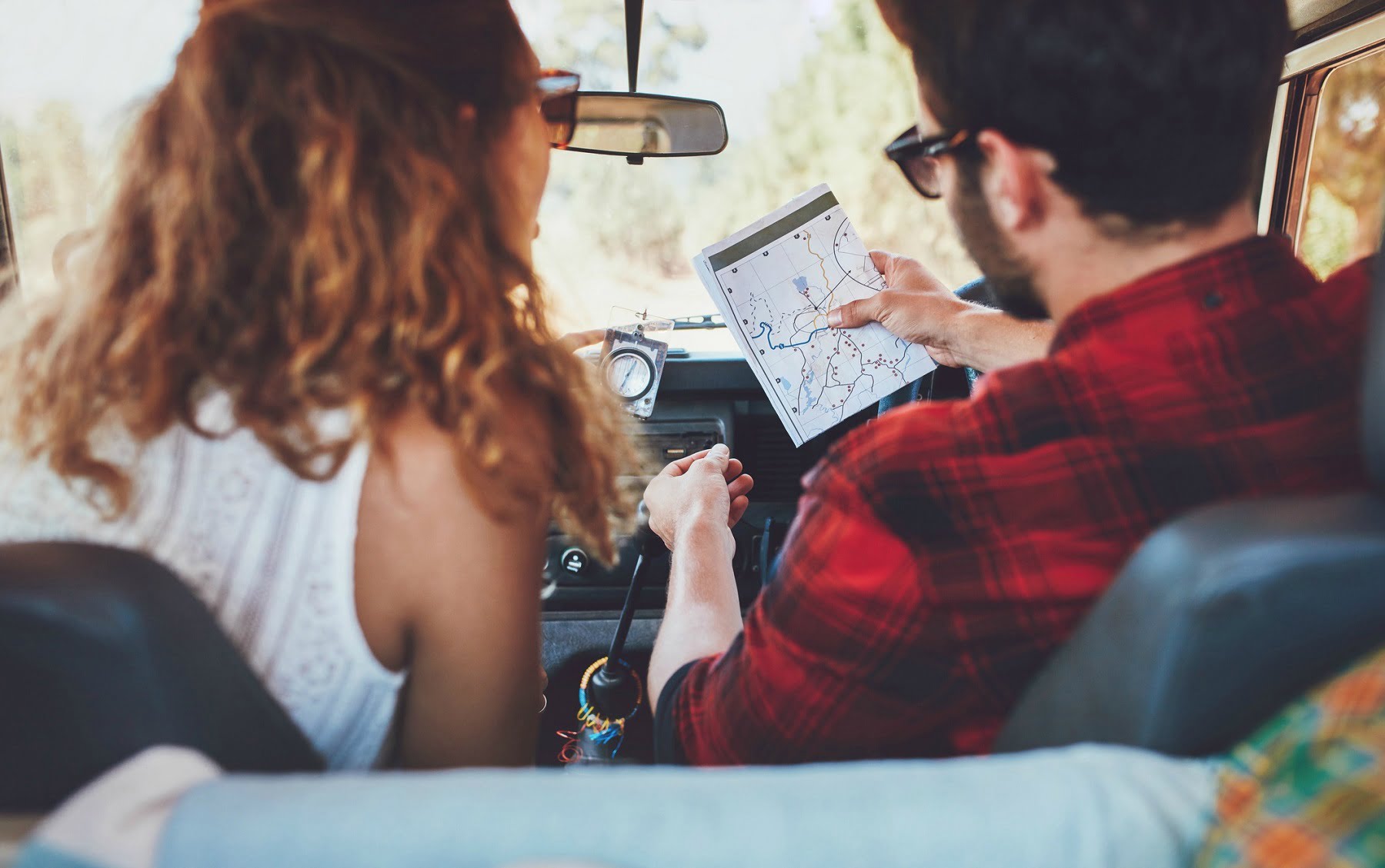 couple looking at a map on a road trip