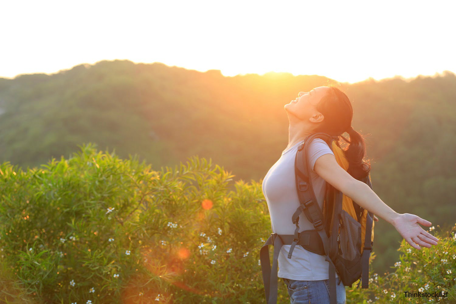 woman embracing nature after a hike