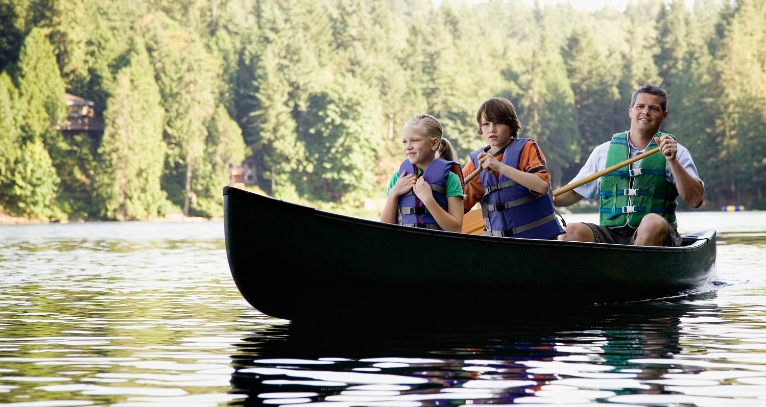 father, daughter, and son in a canoe