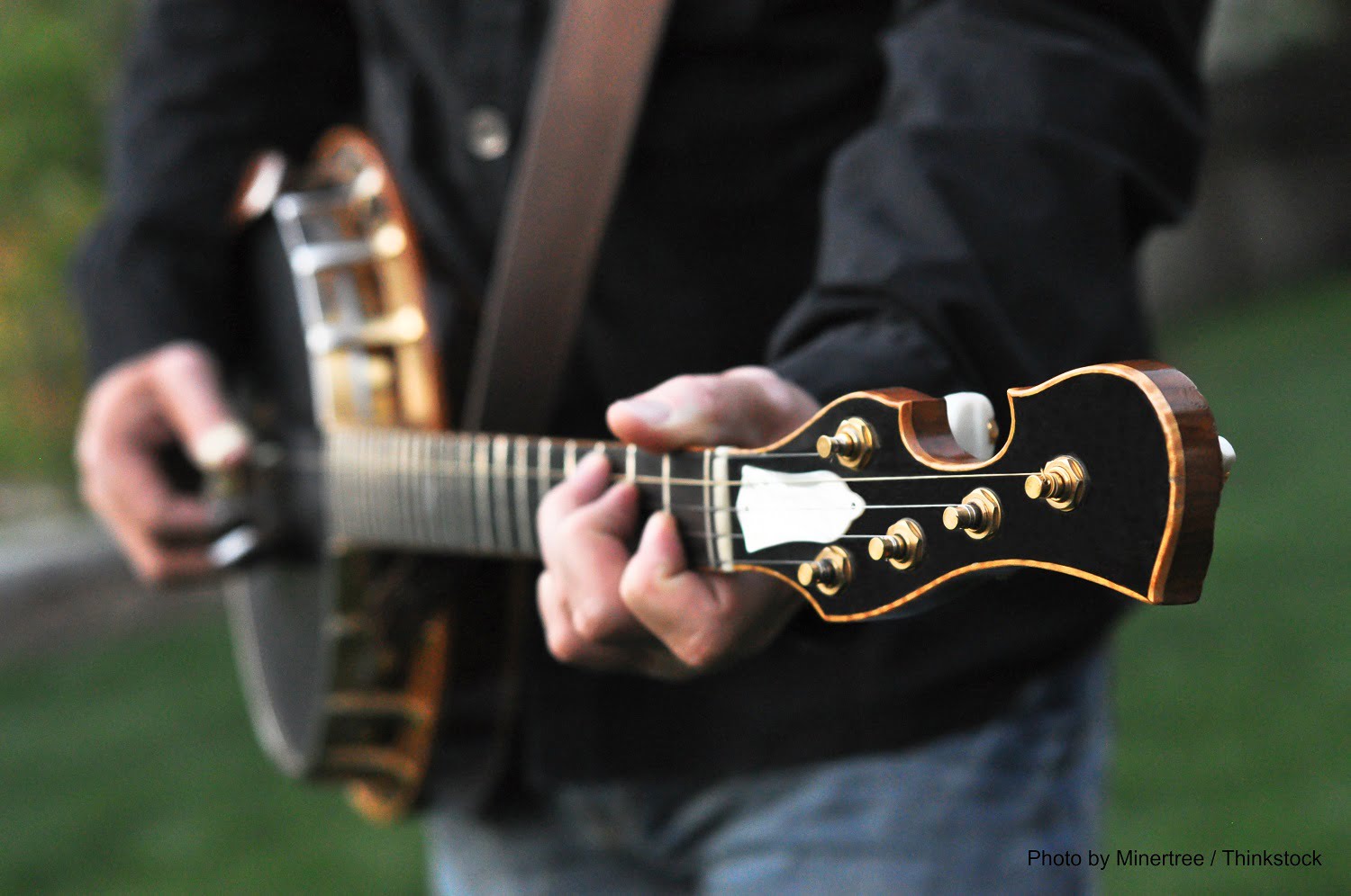 person playing guitar outdoors