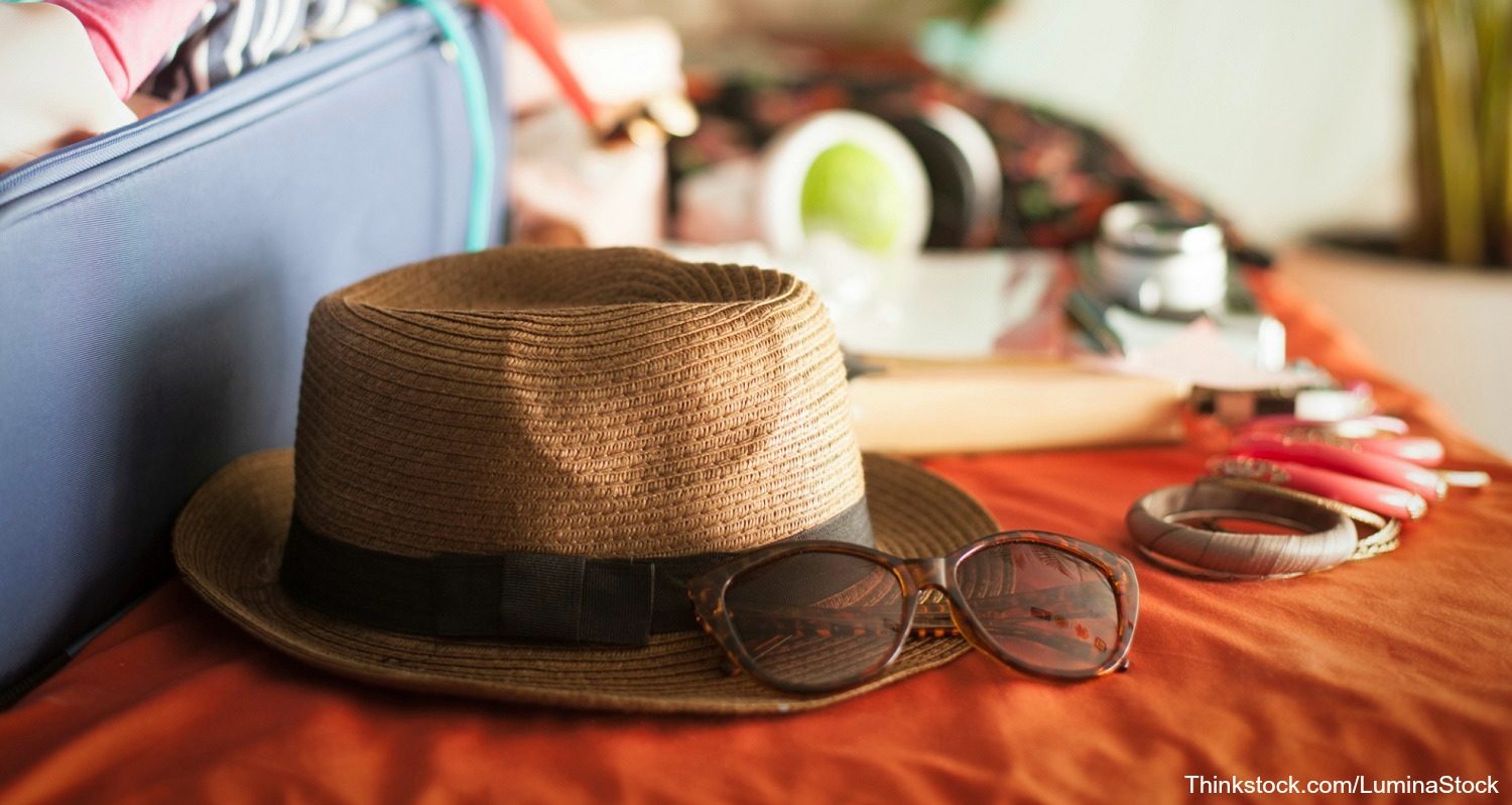 hat and sunglasses being packed for vacation