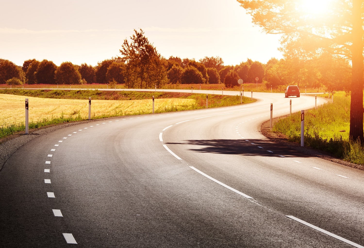 asphalt road view in countryside at beautiful sunset