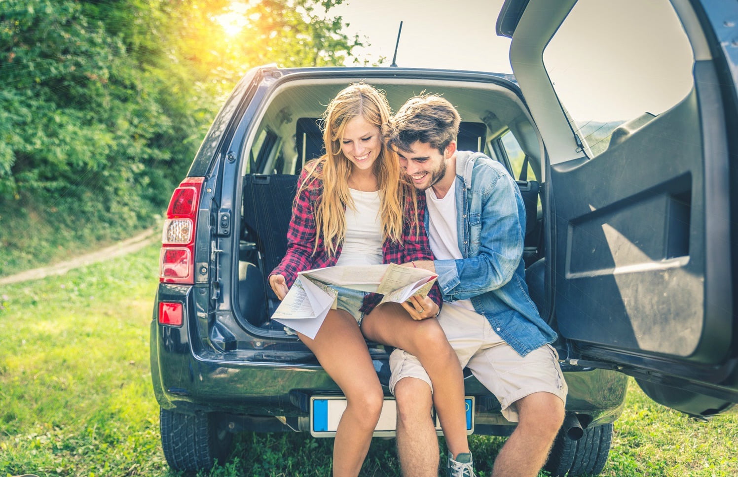 Couple on off road car looking at the map