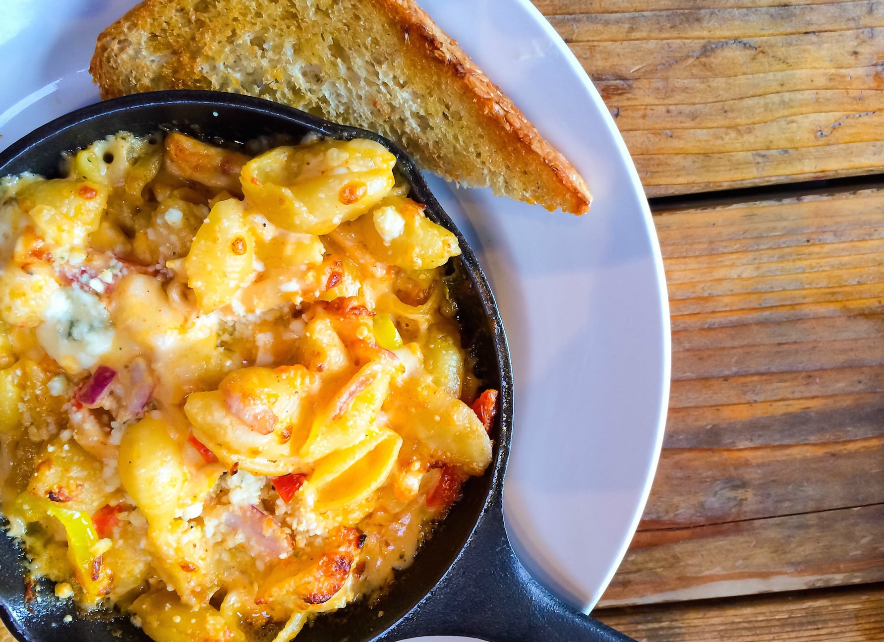 Baked mac and cheese served in a cast iron skillet.