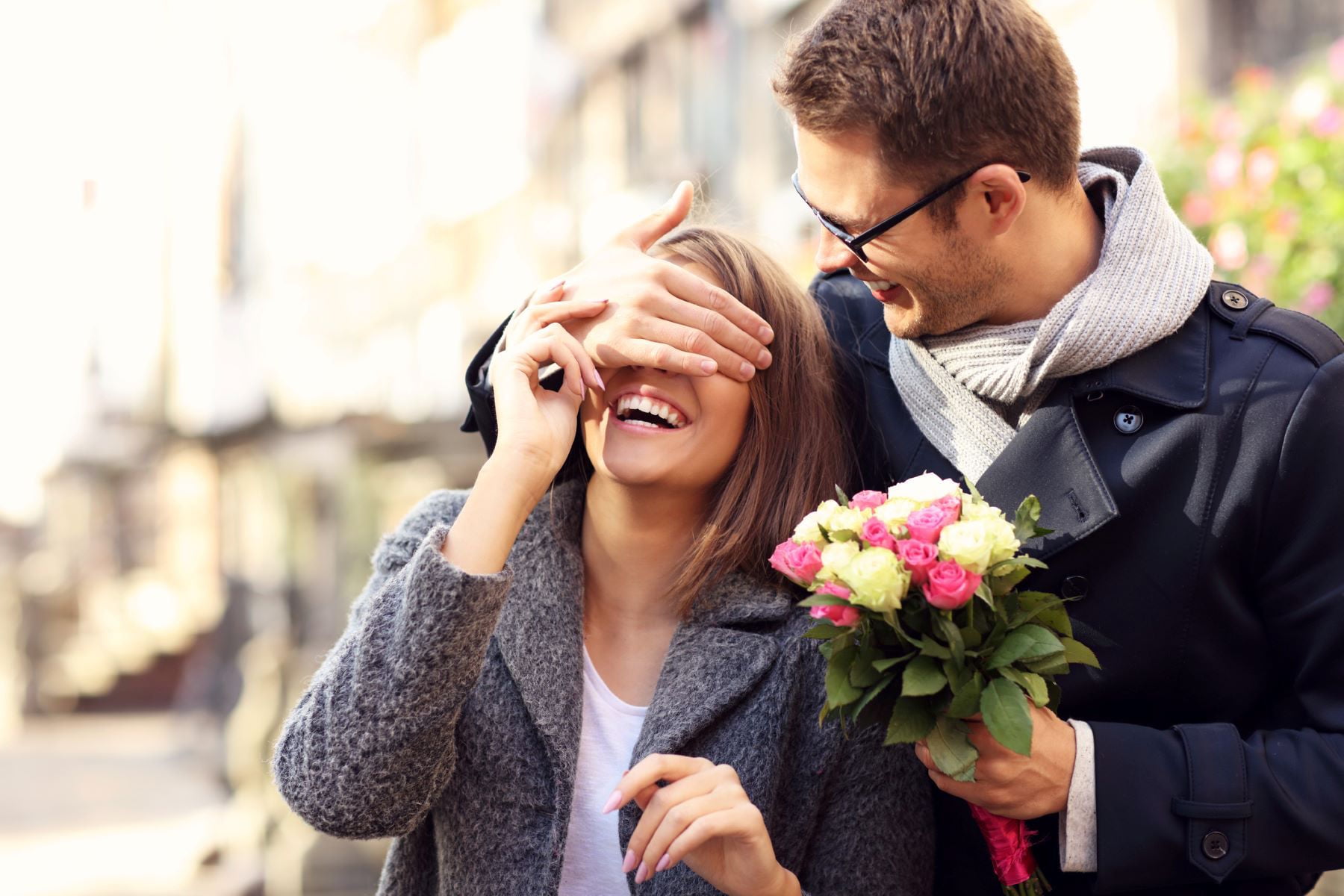 Man giving woman flowers.