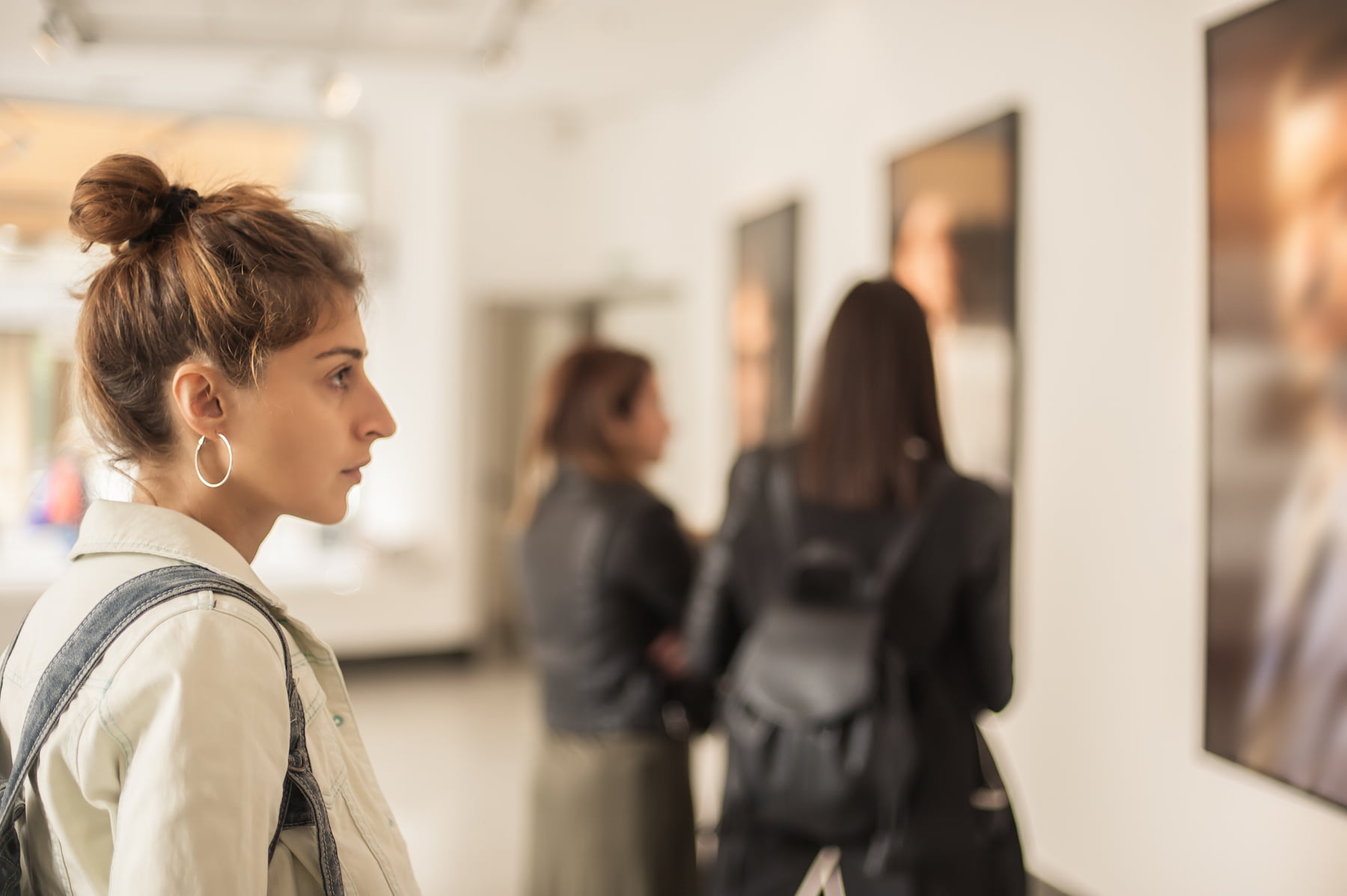 Woman looking at a painting in an art gallery.