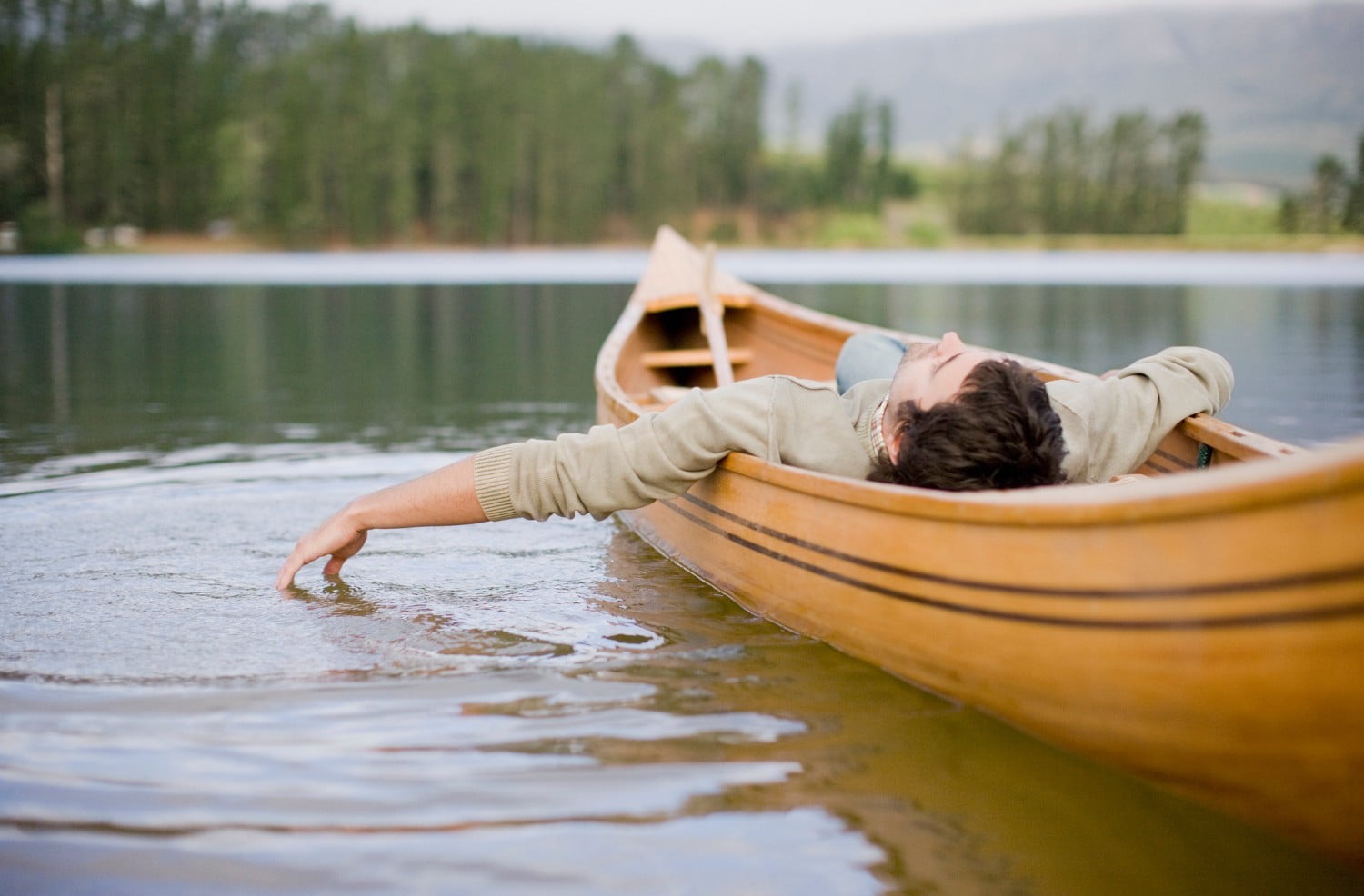 Man floating in a canoe.